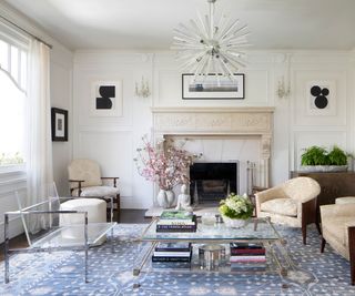 classic living room with transparent chair and blue area rug and fireplace