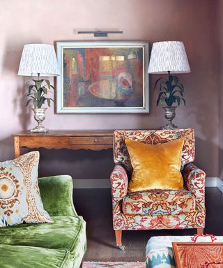 living room with pale pink walls, rich velvet and patterned chairs