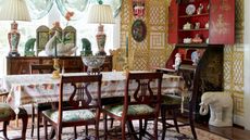 Eclectic dining room with vintage furniture and decor and yellow patterned wallpaper